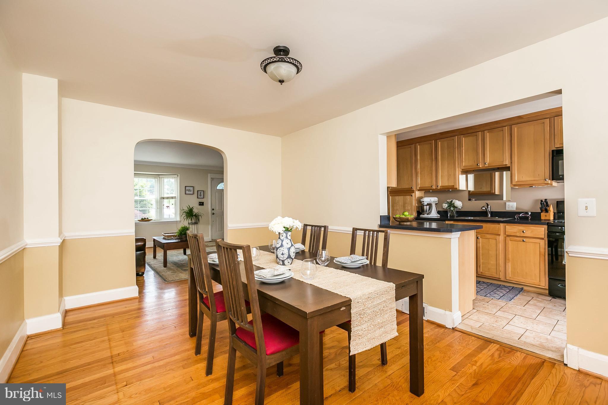 412 Overbrook Road Baltimore, MD 21212 - Photo 3 of 26 a kitchen with a dining table chairs and white cabinets