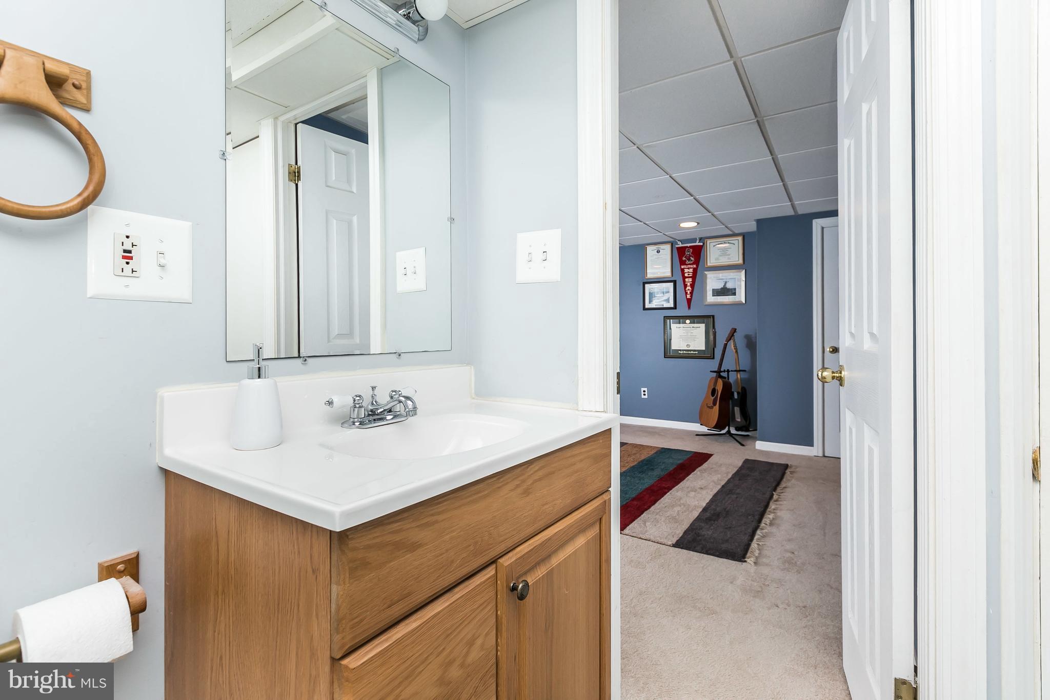 412 Overbrook Road Baltimore, MD 21212 - Photo 22 of 26 a bathroom with a sink and a mirror