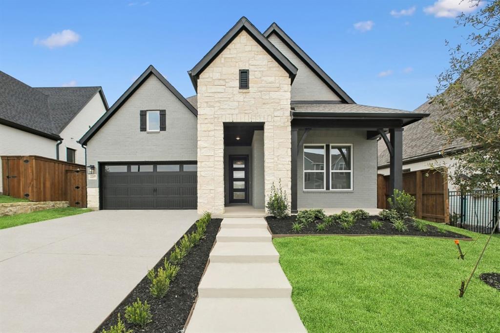 1355 Potenza Road Fate, TX 75087 - Photo 1 of 1 View of front of property featuring stone siding, driveway, a garage, a gate, and a porch