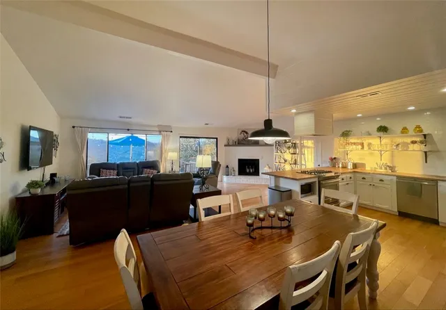 a dining room with furniture and wooden floor