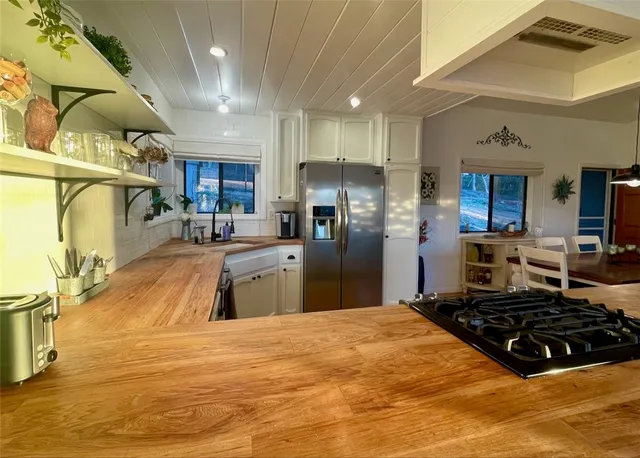 a kitchen with a sink stove and refrigerator
