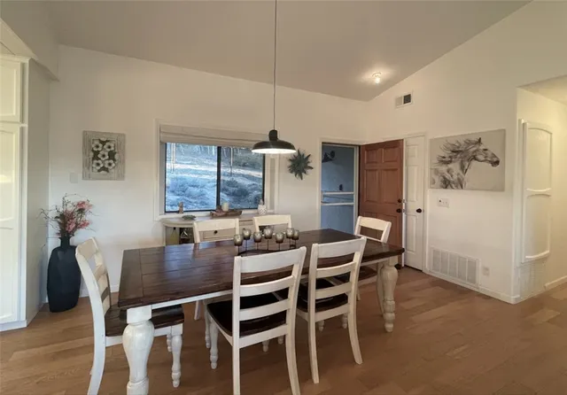 a bedroom with a bed wooden floor and window