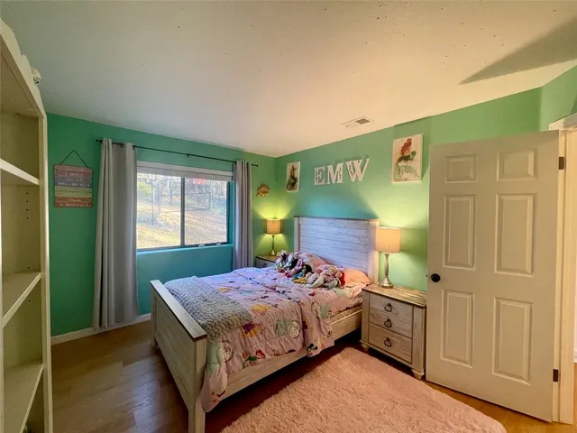 a bedroom with furniture and a window