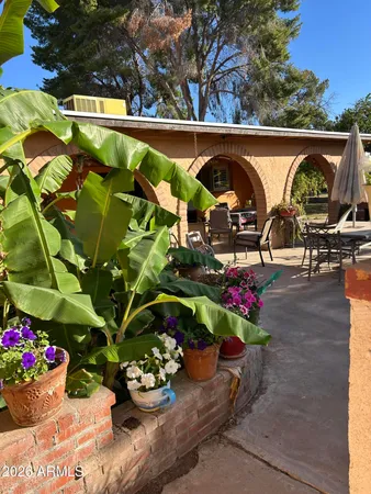 a backyard of a house with table and chairs