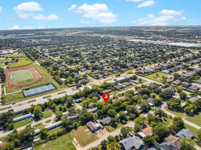an aerial view of residential houses with outdoor space