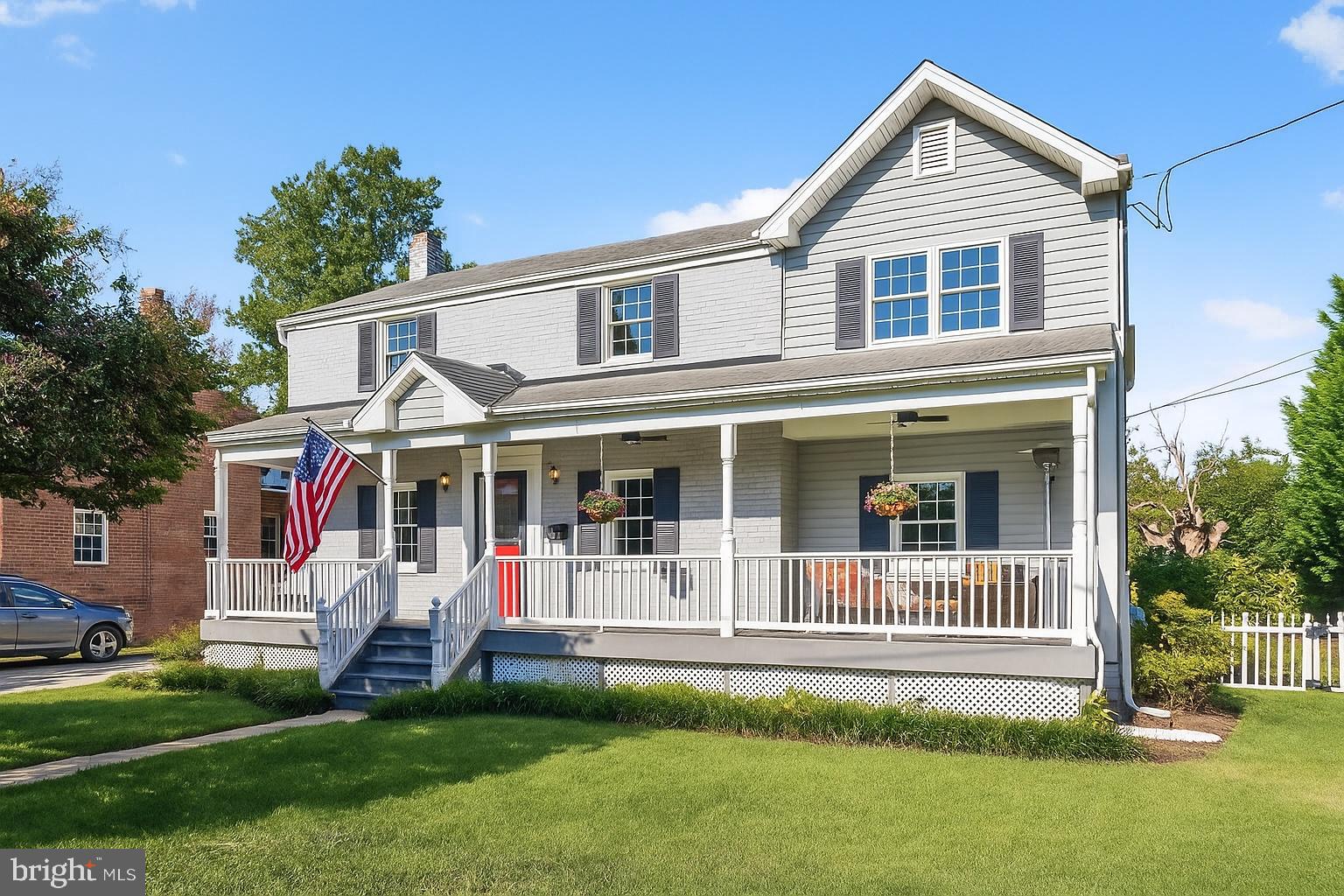 10406 Ewell Avenue Kensington, MD 20895 - Photo 1 of 42 a view of a white house with a small yard and large trees