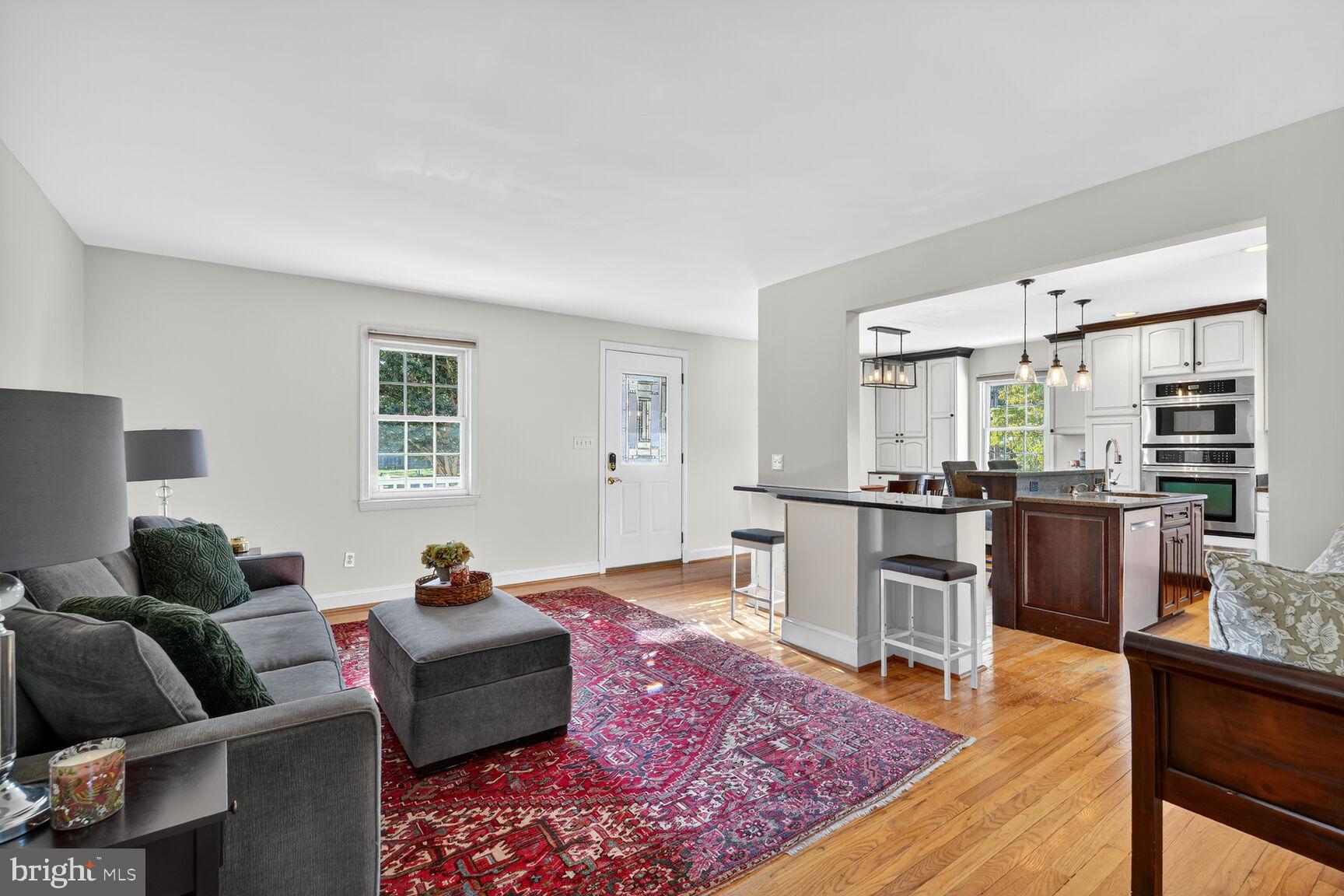 10406 Ewell Avenue Kensington, MD 20895 - Photo 14 of 42 a living room with furniture wooden floor and kitchen view