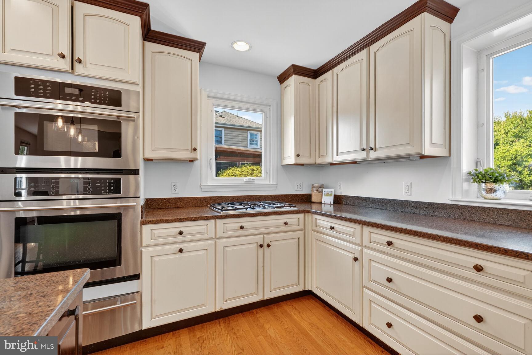 10406 Ewell Avenue Kensington, MD 20895 - Photo 19 of 42 a kitchen with granite countertop white cabinets and stainless steel appliances
