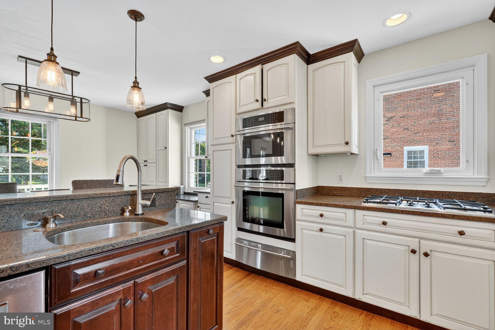 10406 Ewell Avenue Kensington, MD 20895 - Photo 20 of 42 a kitchen with stainless steel appliances granite countertop a sink and cabinets