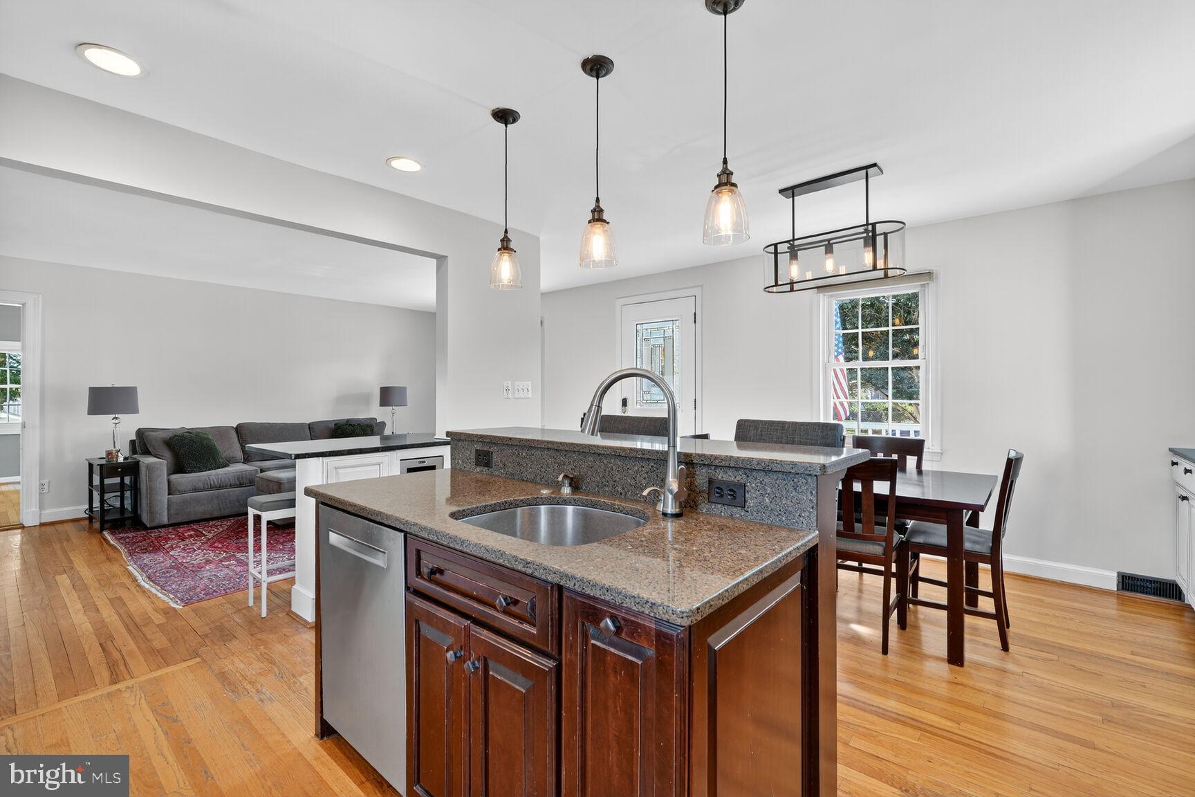 10406 Ewell Avenue Kensington, MD 20895 - Photo 21 of 42 a kitchen with a stove a counter space and wooden floor