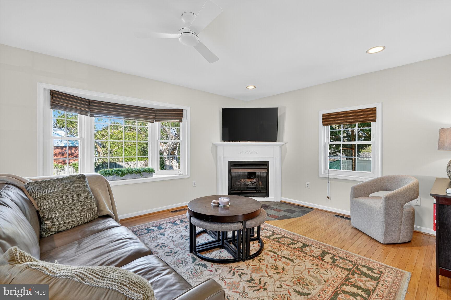 10406 Ewell Avenue Kensington, MD 20895 - Photo 22 of 42 a living room with furniture and a fireplace