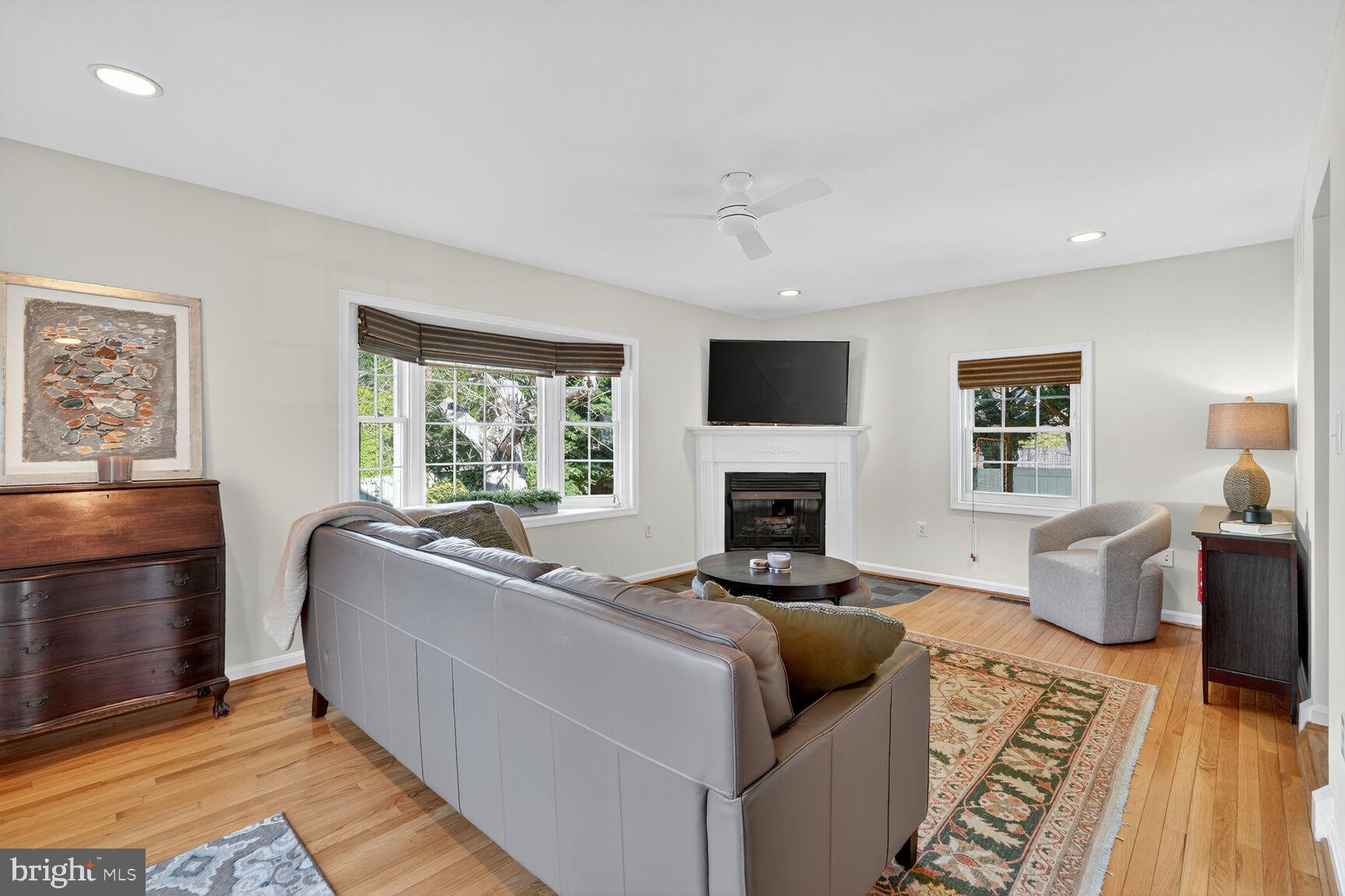 10406 Ewell Avenue Kensington, MD 20895 - Photo 23 of 42 a living room with furniture and a fireplace