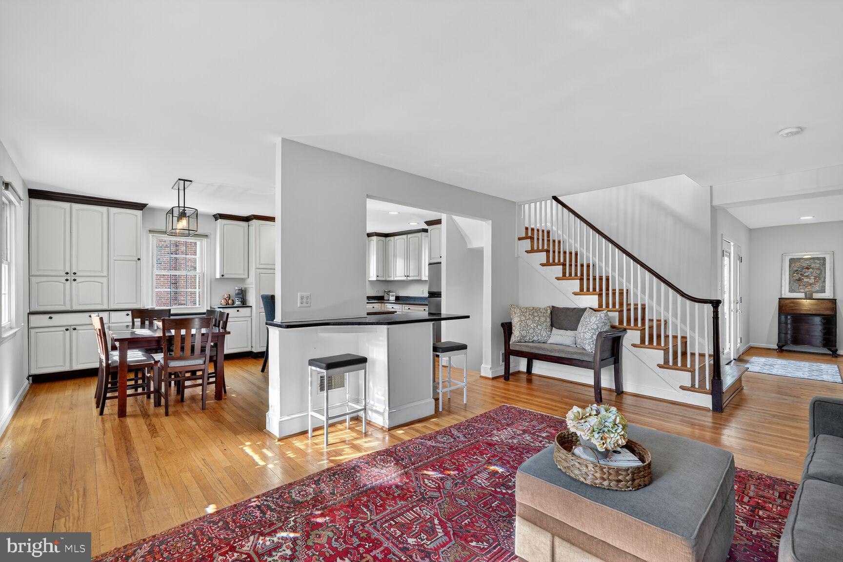 10406 Ewell Avenue Kensington, MD 20895 - Photo 25 of 42 a living room with furniture wooden floor and a dining table