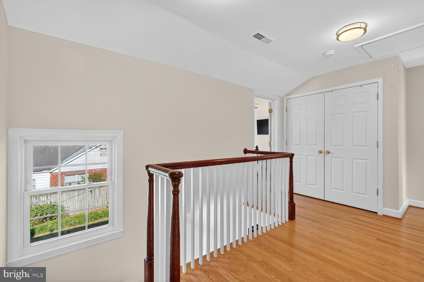 10406 Ewell Avenue Kensington, MD 20895 - Photo 30 of 42 a view of hallway with wooden floor and stairs