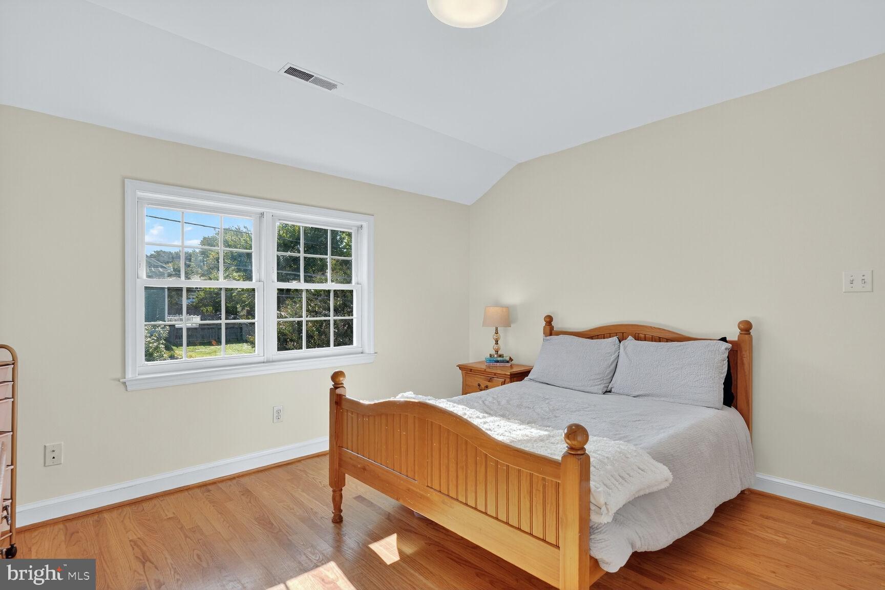 10406 Ewell Avenue Kensington, MD 20895 - Photo 35 of 42 a bedroom with a bed and wooden floor