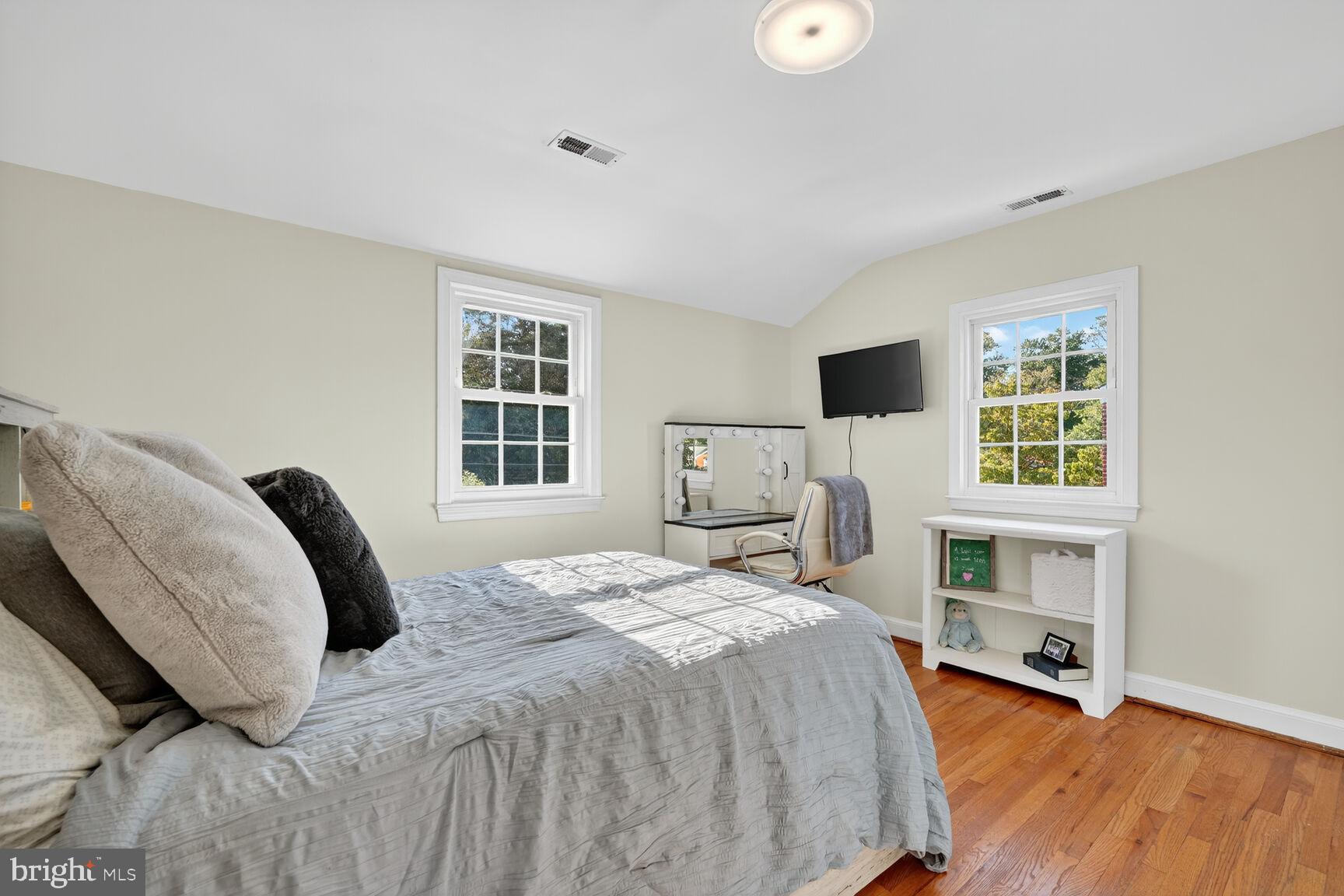 10406 Ewell Avenue Kensington, MD 20895 - Photo 37 of 42 a bedroom with a bed and a flat screen tv