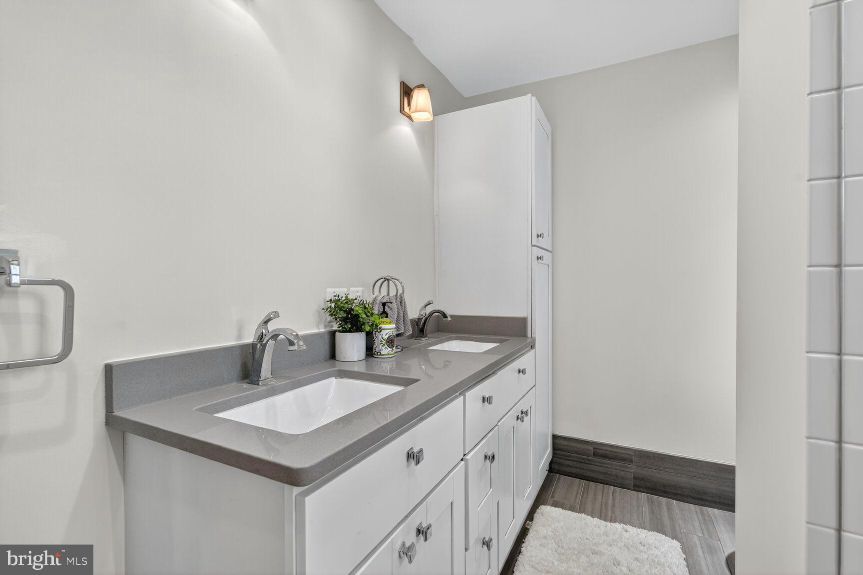 10406 Ewell Avenue Kensington, MD 20895 - Photo 39 of 42 a bathroom with a sink and a mirror