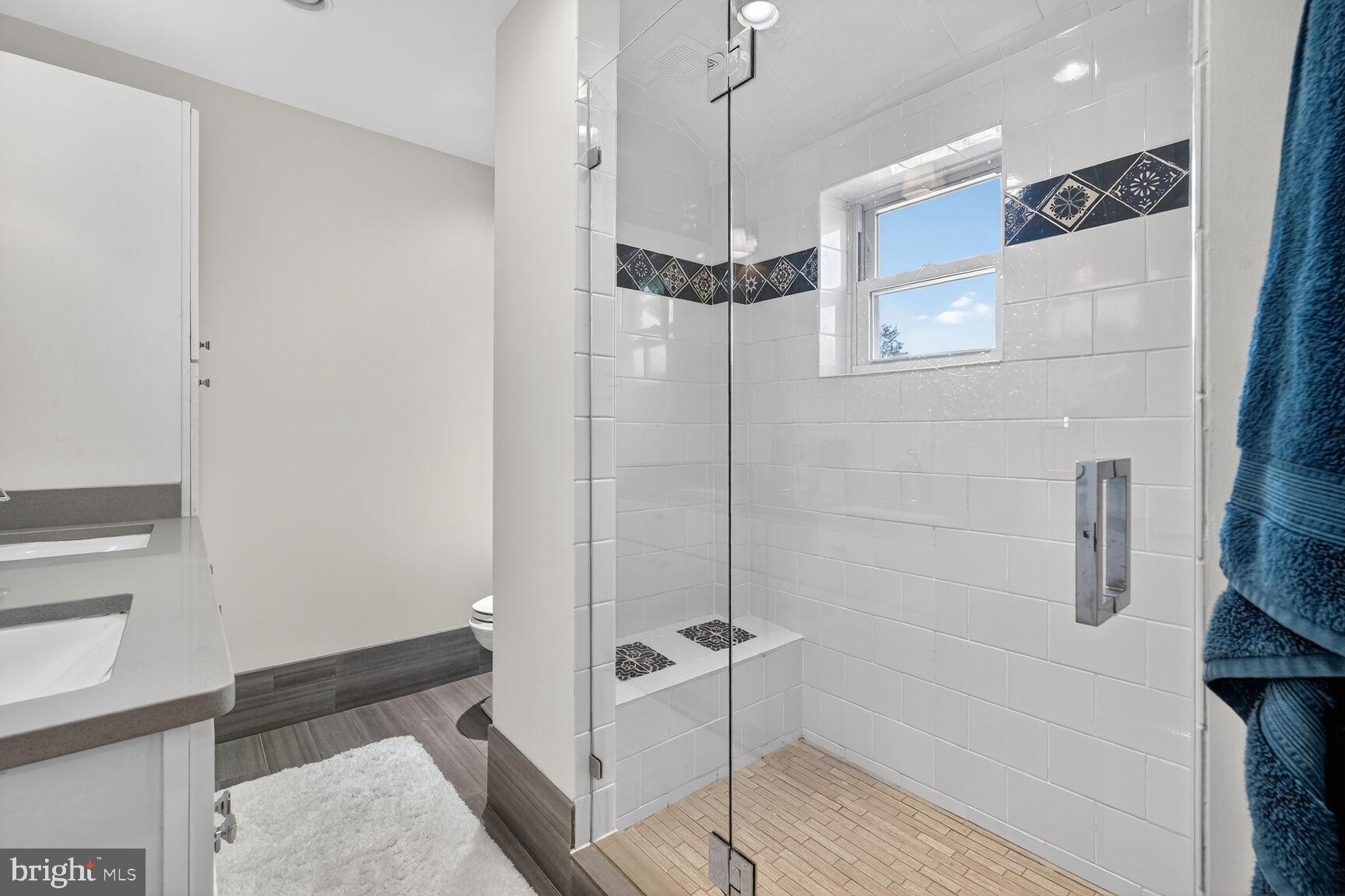 10406 Ewell Avenue Kensington, MD 20895 - Photo 40 of 42 a bathroom with a bathtub and a shower