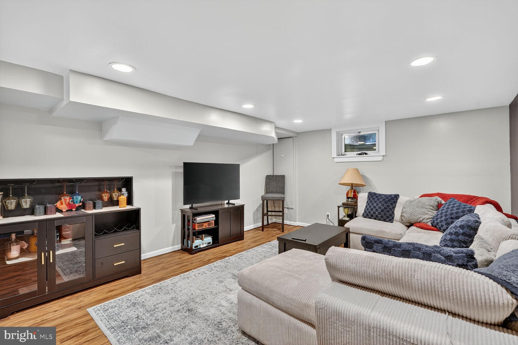 10406 Ewell Avenue Kensington, MD 20895 - Photo 41 of 42 a living room with furniture and a flat screen tv
