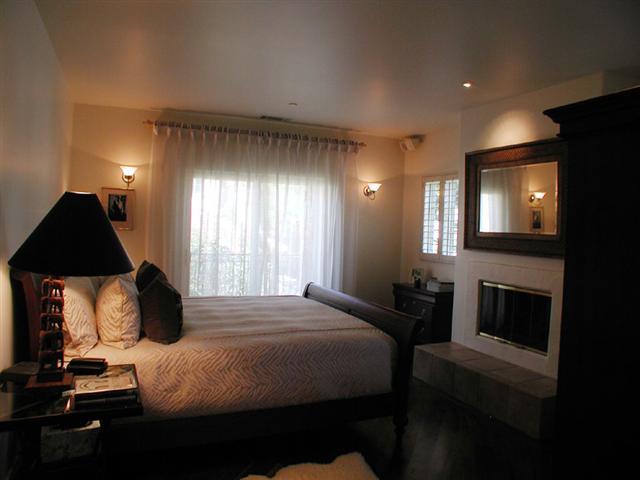 71 Olive Mill Road Montecito, CA 93108 - Photo 9 of 12 a bedroom with a bed and a fireplace