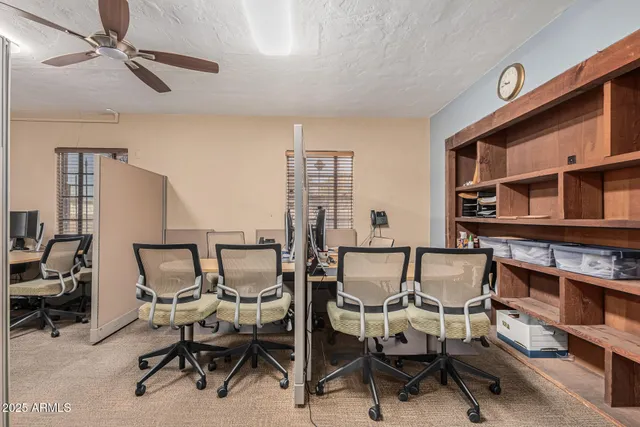 a view of a dining room with furniture and a window