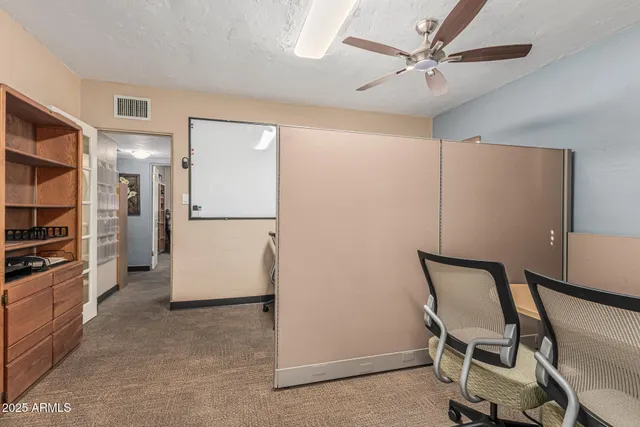 a view of a kitchen with refrigerator and wooden floor