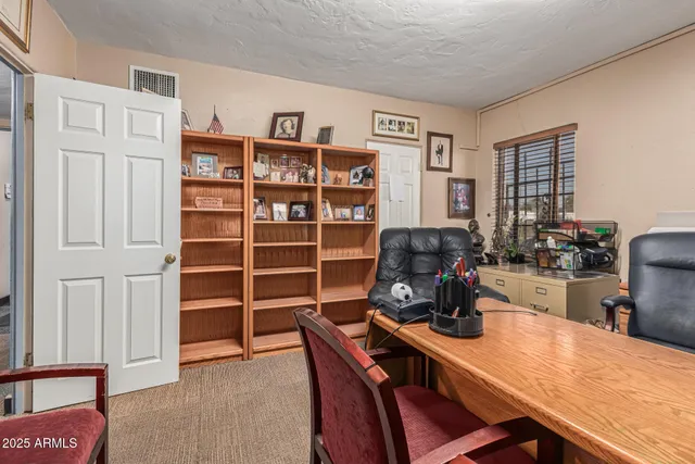 a view of a workspace with furniture and wooden floor