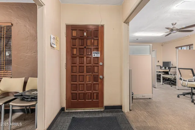 a view of a livingroom with workspace and a window