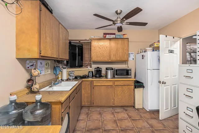 a kitchen with stainless steel appliances a refrigerator sink and microwave