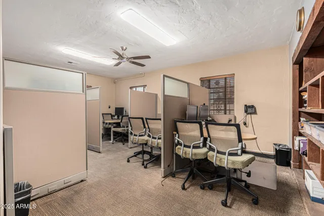 a view of a livingroom with workspace and a window