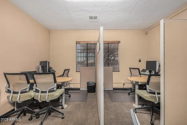 a work room with furniture and a view of kitchen