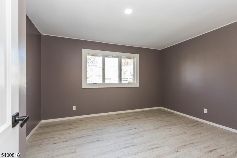 1 Pine Court Little Falls, NJ 07424 - Photo 13 of 24 a view of a room with wooden floor and windows