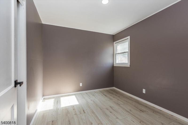 1 Pine Court Little Falls, NJ 07424 - Photo 14 of 24 an empty room with wooden floor and windows
