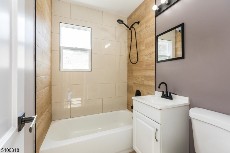1 Pine Court Little Falls, NJ 07424 - Photo 15 of 24 a bathroom with a sink a mirror toilet and bathtub