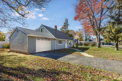 a view of a house with a yard covered in snow