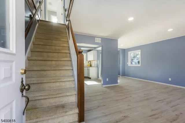a view of an entryway with wooden floor and door