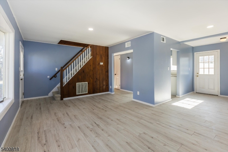 1 Pine Court Little Falls, NJ 07424 - Photo 4 of 24 a view of an empty room with wooden floor and a window