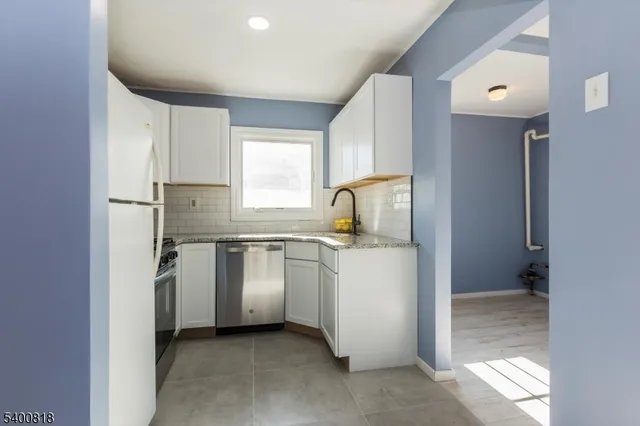 a kitchen with a refrigerator and window