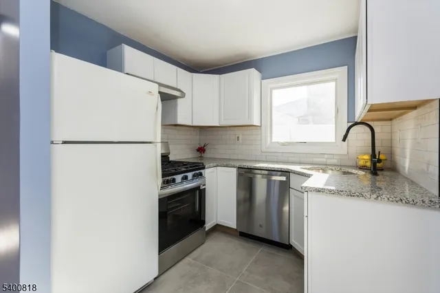 a kitchen with a refrigerator sink and stove