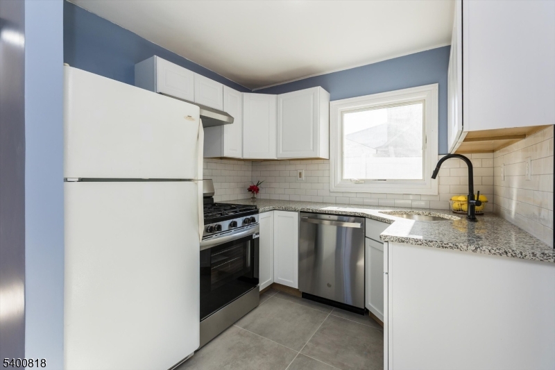 1 Pine Court Little Falls, NJ 07424 - Photo 8 of 24 a kitchen with a refrigerator sink and stove