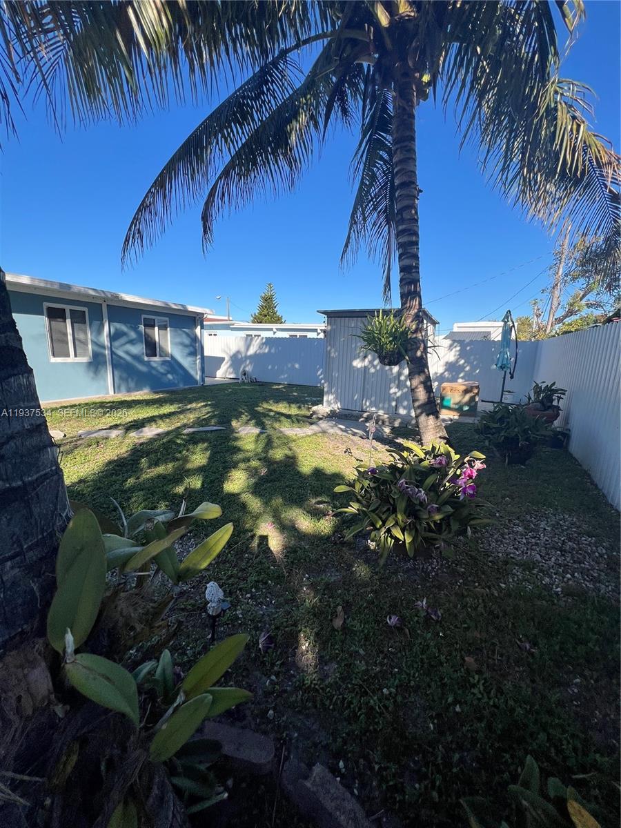 1461 East 9th Court Hialeah, FL 33010 - Photo 21 of 31 a view of a backyard of a house with a yard