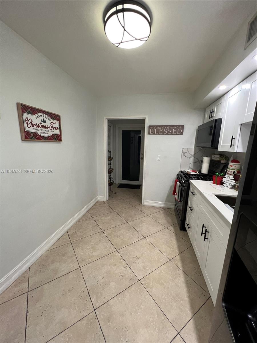 1461 East 9th Court Hialeah, FL 33010 - Photo 5 of 31 a view of a kitchen with storage and utility