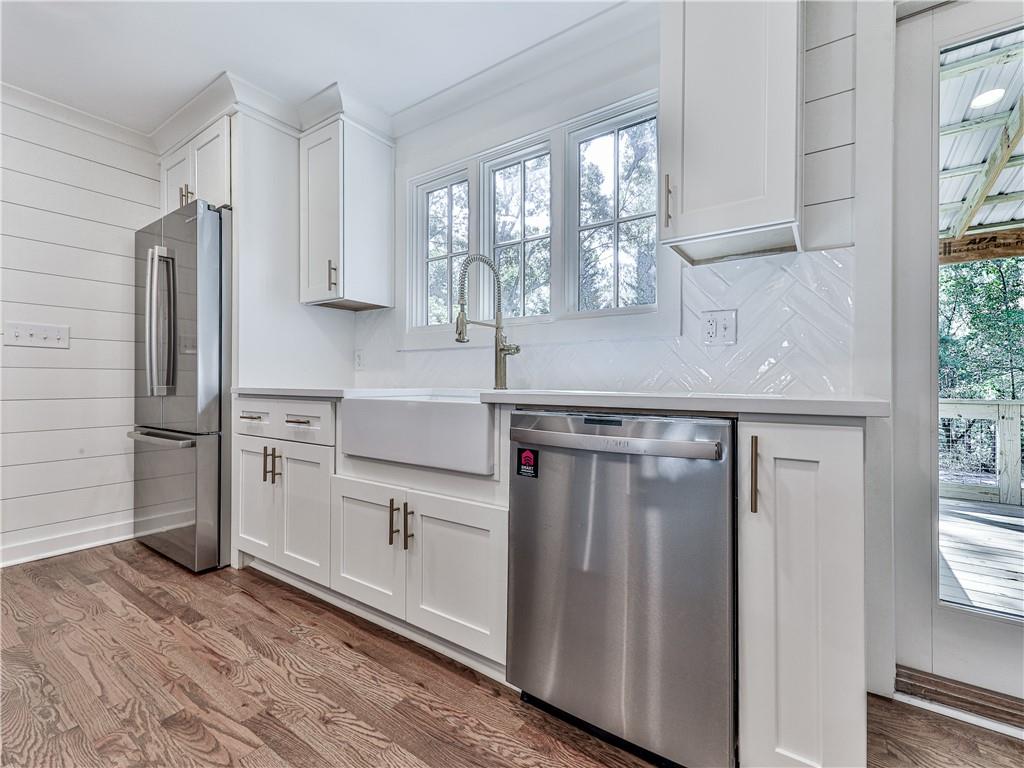 633 Butterworth Road Canton, GA 30114 - Photo 10 of 55 a kitchen with white cabinets and white appliances