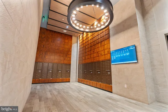 an empty room with wooden floor and entryway