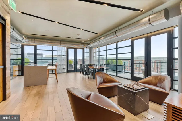 a dining room with furniture a chandelier and wooden floor