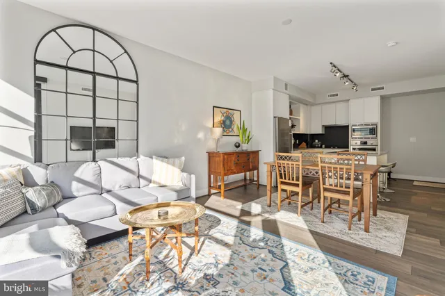 a living room with furniture and wooden floor