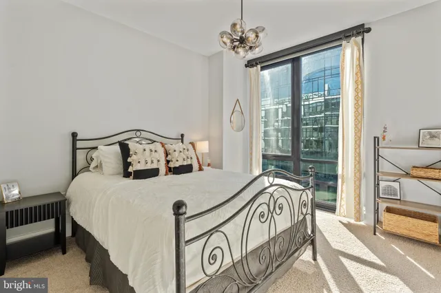 a bedroom with a bed next to a window with outer view