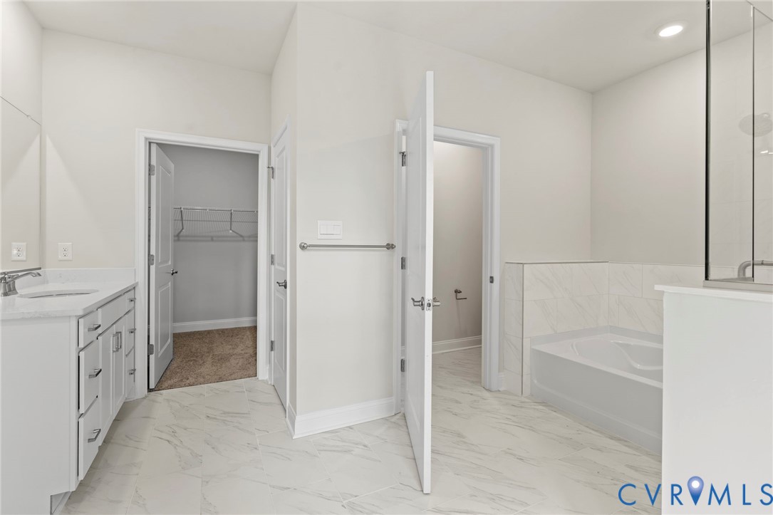 16801 Barmer Road Chesterfield, VA 23832 - Photo 11 of 20 a bathroom with a granite countertop sink a mirror and a bathtub