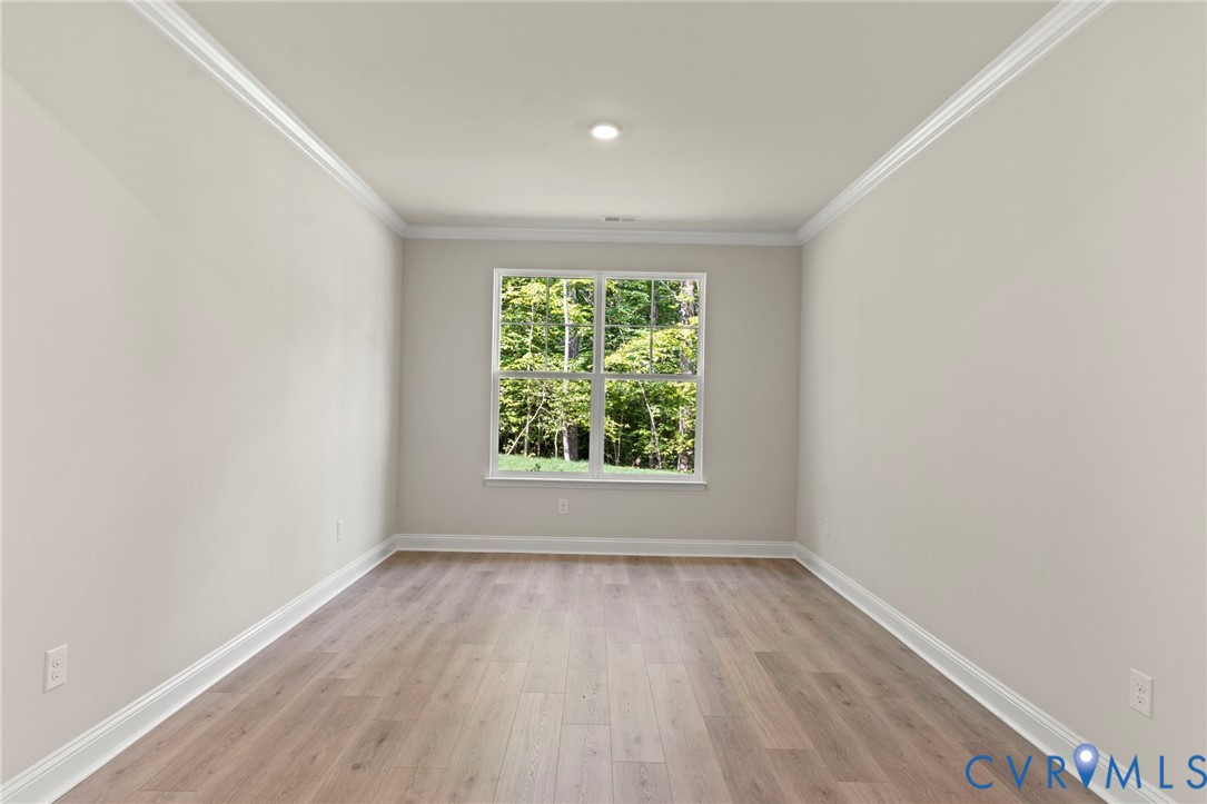 16801 Barmer Road Chesterfield, VA 23832 - Photo 10 of 20 an empty room with wooden floor and windows