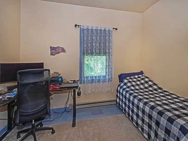 a bedroom with a workspace